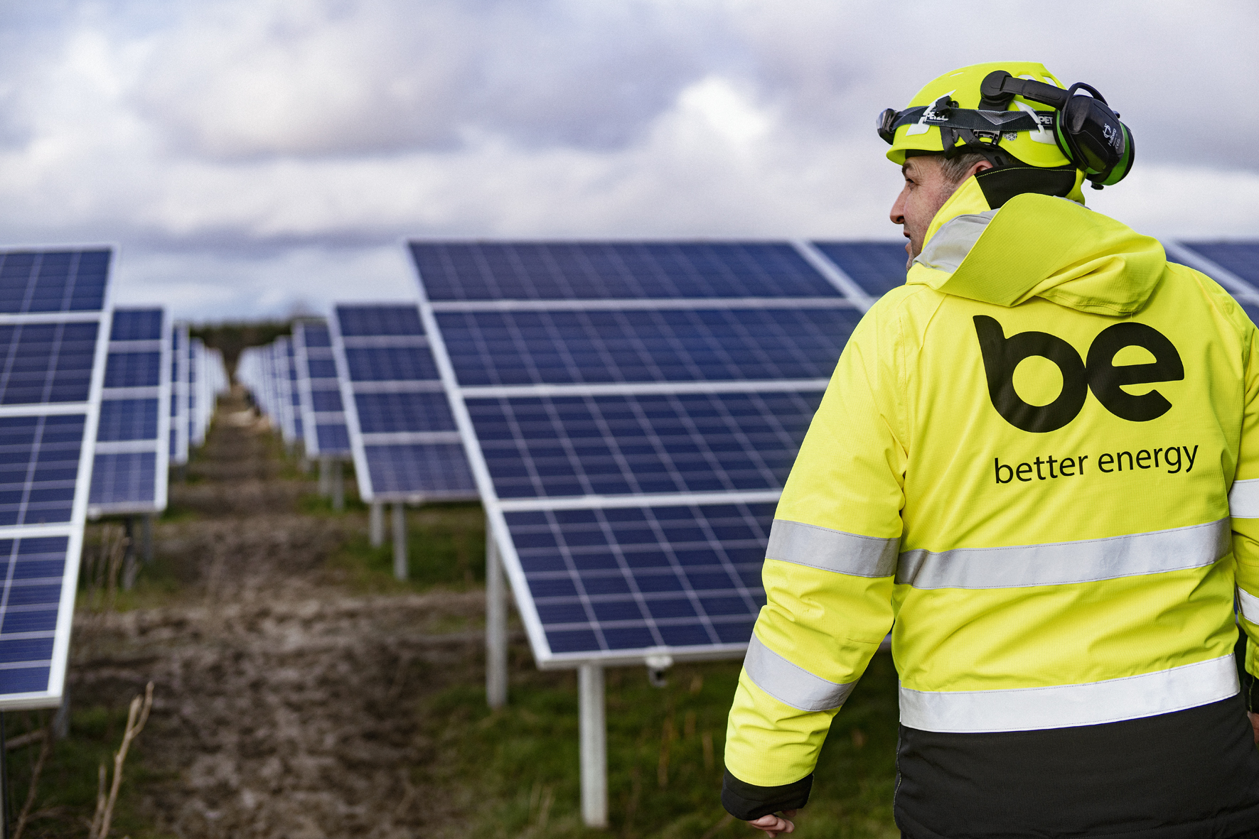 Man in yellow vest in solar park
